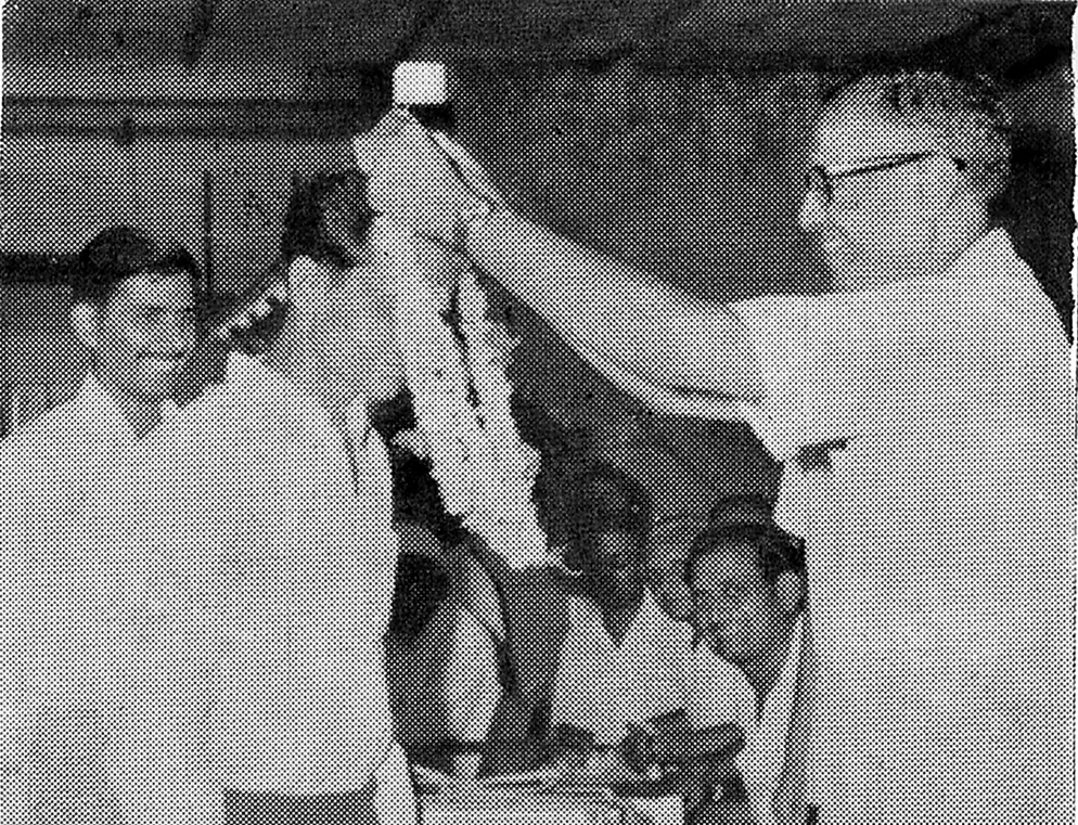 The Mayor of Baroda, Dr Thakorbhai Patel, garlanding a Supervisor of the Company in recognition of his services.