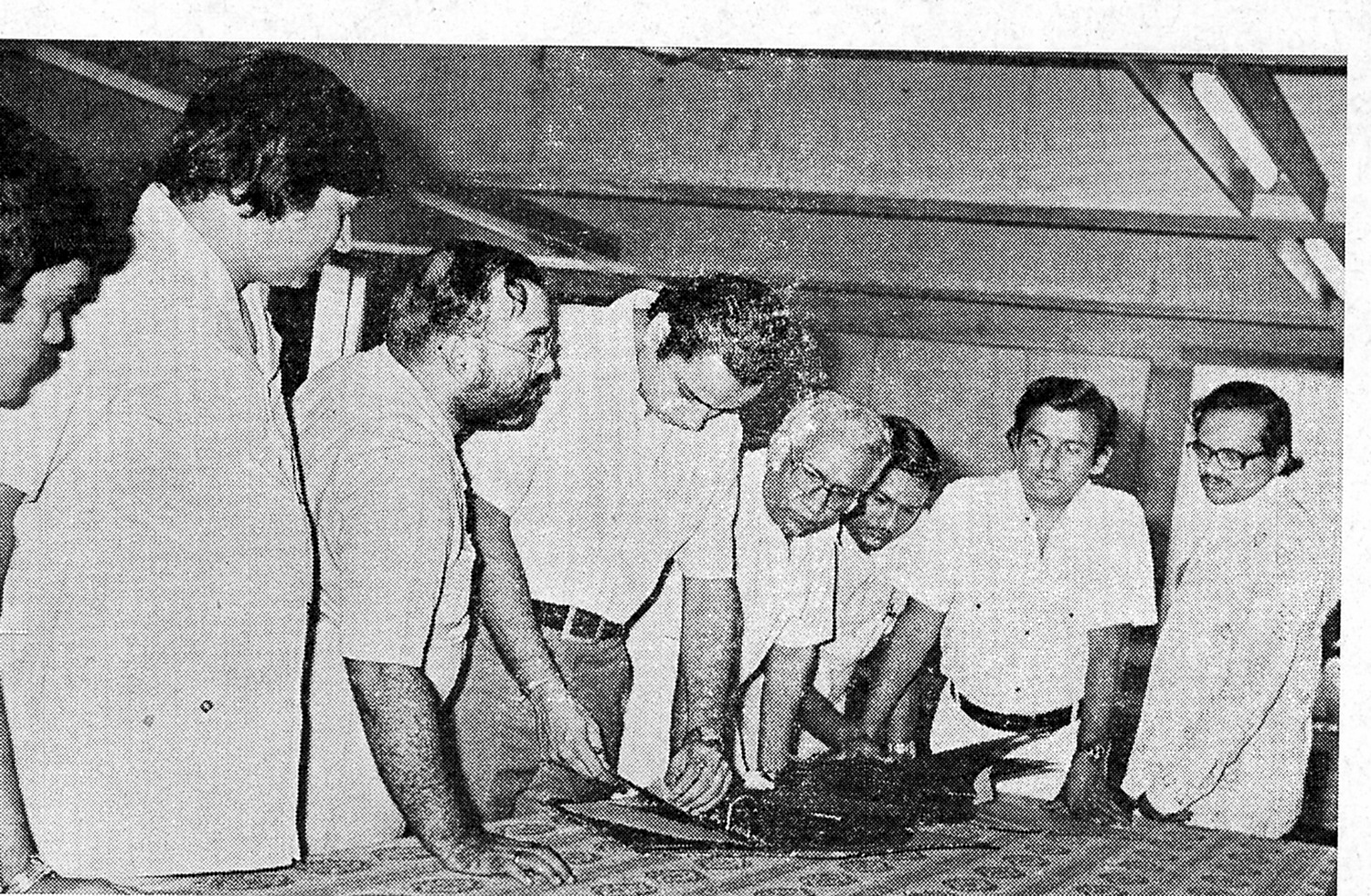 Shri Bharatbhai Patel examining new cloth samples at the Sales Conference, with the indenting agents.